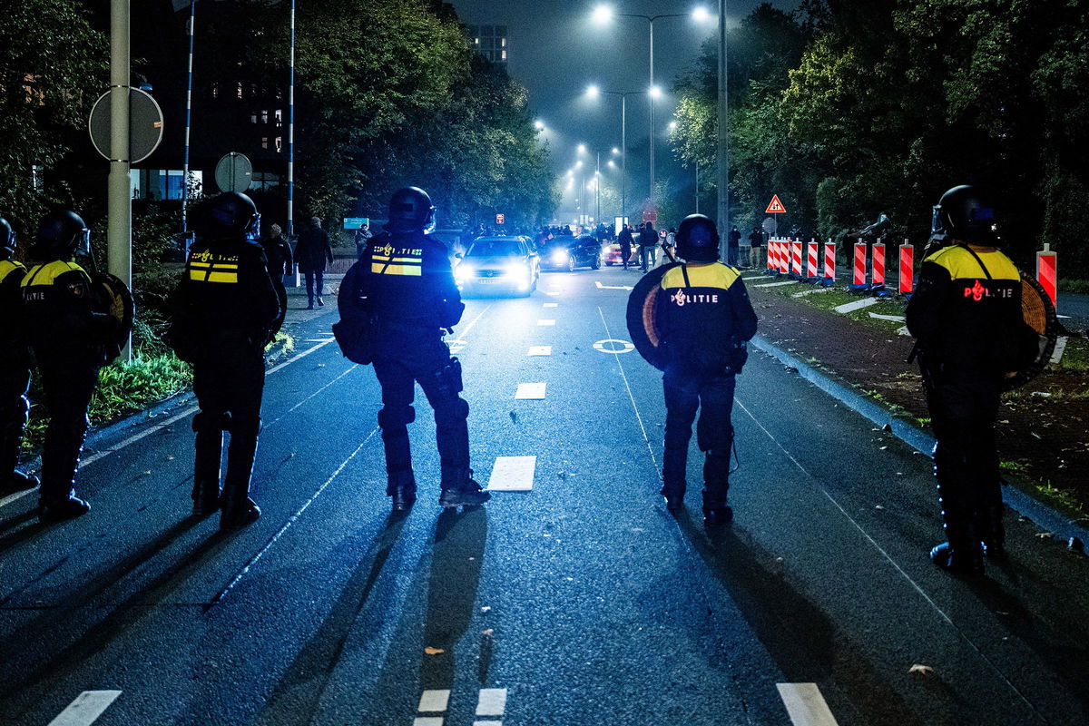 <i>Jeroen Jumelet/AFP/ANP/Getty Images via CNN Newsource</i><br/>Police officers stand near a pro-Palestinian demonstration during a soccer match between Ajax Amsterdam and Maccabi Tel Aviv in Amsterdam