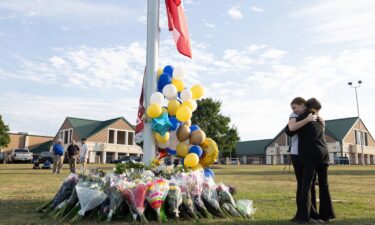 Students embrace near a makeshift memorial at Apalachee High School on September 5 in Winder