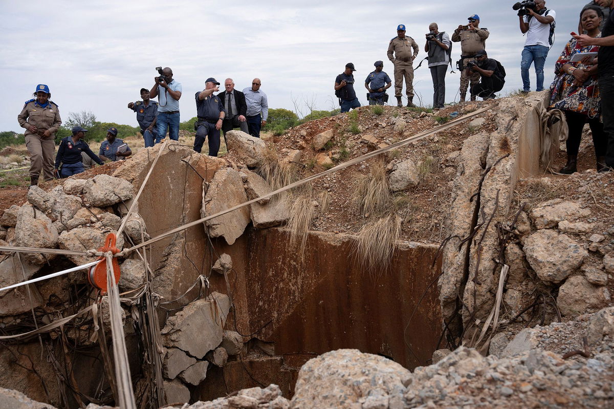 <i>Ihsaan Haffejee/Reuters via CNN Newsource</i><br/>South African government officials inspect the abandoned Stilfontein mine