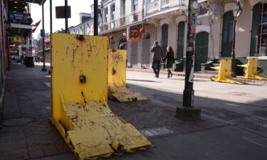 Tourist walk past temporary barriers on Bourbon Street on January 2.