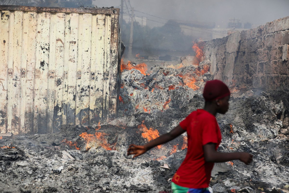 <i>Nipah Dennis/AFP/Getty Images via CNN Newsource</i><br/>People try to salvage items after the fire at the Kantamanto market