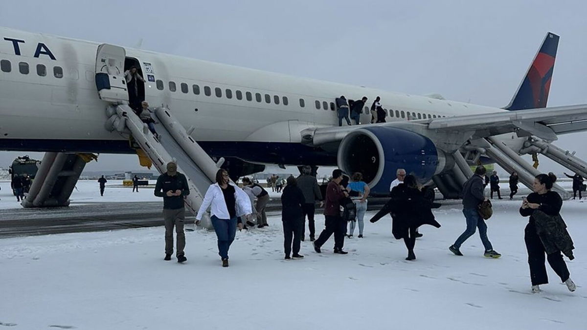 Passengers exit a Delta airplane at Hartsfield-Jackson Airport in Atlanta after an emergency on the runway on Friday, January 10.