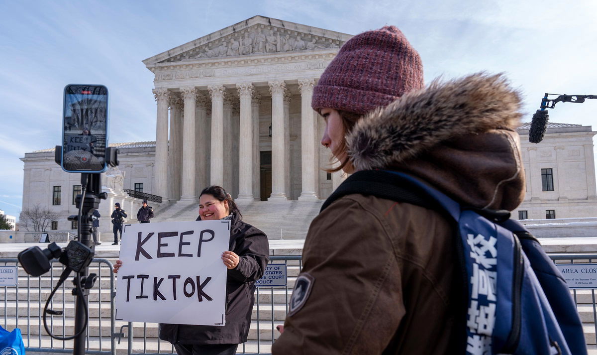 <i>Jacquelyn Martin/AP via CNN Newsource</i><br/>Callie Goodwin of South Carolina holds a sign in support of TikTok outside the Supreme Court on Friday