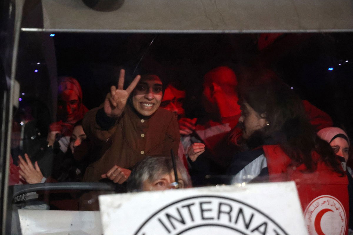 <i>Zain Jaafar/AFP/Getty Images via CNN Newsource</i><br/>Palestinian journalist Rula Hassanein inside a Red Cross bus carrying some 90 prisoners released by Israel in the early hours of January 20