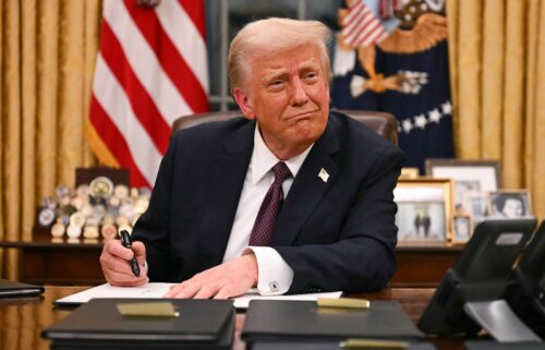 President Donald Trump signs executive orders in the Oval Office of the White House in Washington