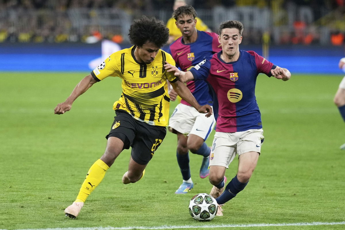 <i>Matthias Schrader/AP via CNN Newsource</i><br/>Barcelona's Gavi and Dortmund's Karim Adeyemi challenge for the ball.
