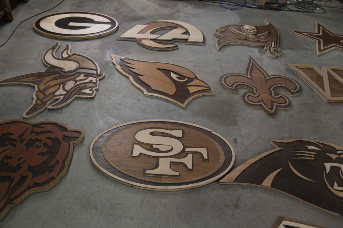 <i>WTMJ via CNN Newsource</i><br/>Several of the NFL logos local wood artist Ike Wynter created for the draft in Green Bay.