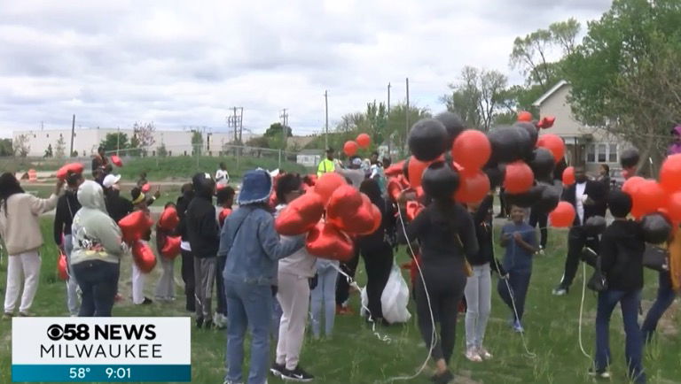 <i>WDJT via CNN Newsource</i><br/>Dozens of people came together carrying red and black balloons to remember Torrell Coleman
