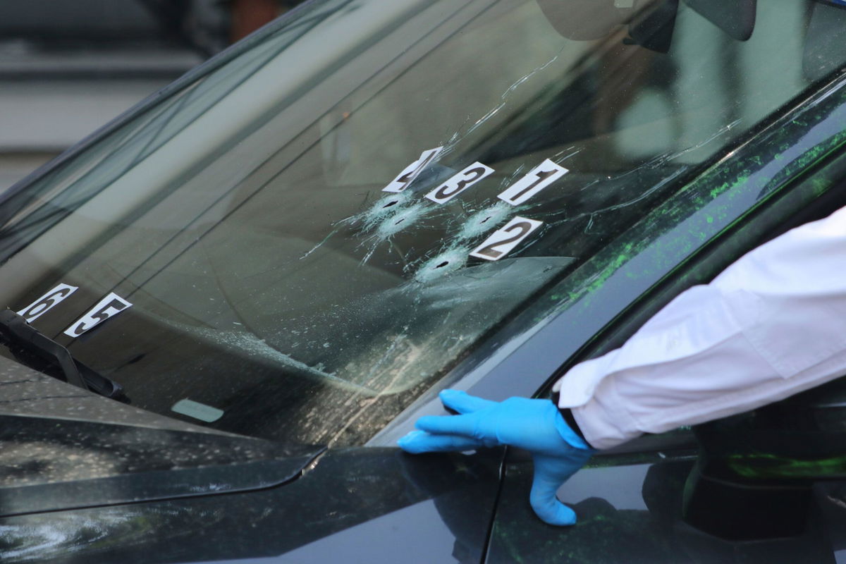 <i>Tristan Velazquez/AP via CNN Newsource</i><br/>Crime scene investigators at the site where the personal secretary and an adviser to Mexico City's mayor were killed by gunmen on a motorcycle