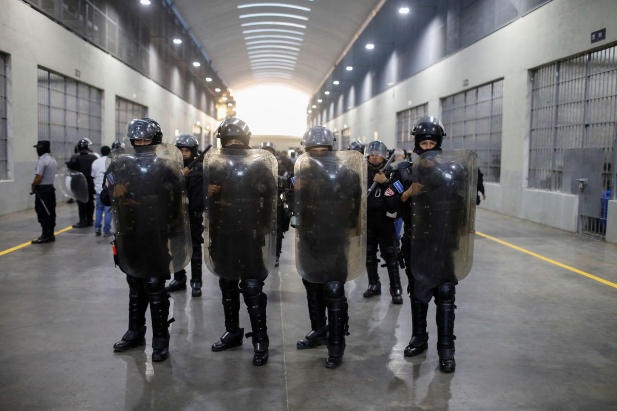 <i>Jose Cabezas/Reuters via CNN Newsource</i><br/>Police officers stand guard during a media tour at the Terrorism Confinement Center (CECOT) prison in Tecoluca