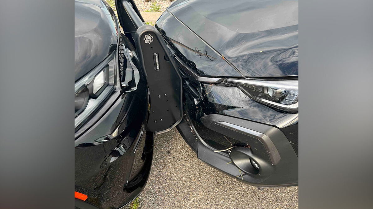 Police pin-in suspect vehicle to prevent escape.