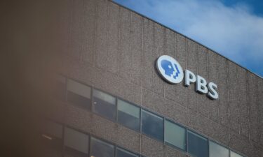 A sign for the Public Broadcasting Service is seen on its building headquarters in Arlington