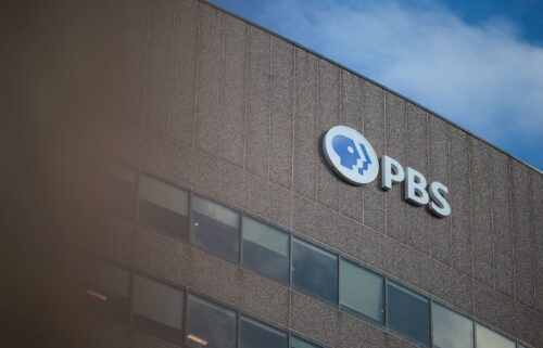 A sign for the Public Broadcasting Service is seen on its building headquarters in Arlington