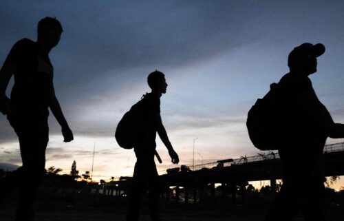 Venezuelans walk to a US Border Patrol processing center after they crossed the Rio Grande river and over the razor wire to cross into Eagle Pass