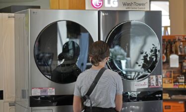 A customer looks at LG washing machines and dryers.