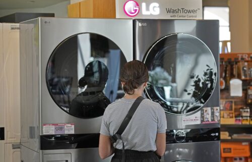 A customer looks at LG washing machines and dryers.