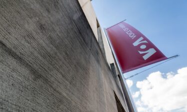 A banner hangs on the side of the Voice of America (VOA) headquarters building in Washington