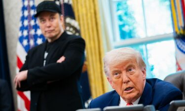 President Donald Trump speaks during a news conference with Elon Musk (L) in the Oval Office of the White House in Washington