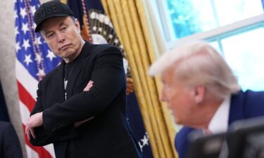 Tesla CEO Elon Musk listens as President Donald Trump speaks to reporters in the Oval Office of the White House on May 30