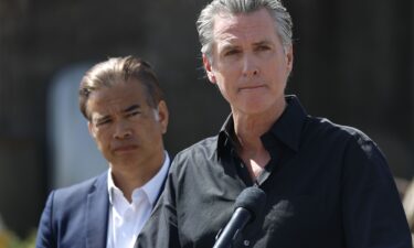 California Governor Gavin Newsom (R) and California Attorney general Rob Bonta look on during a news conference at Gemperle Orchard on April 16