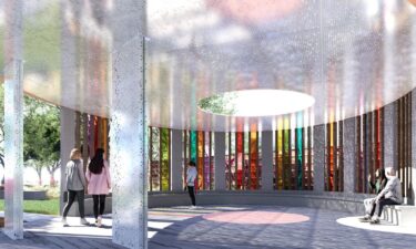 A visitor views photos at the Pulse Interim Memorial in Orlando. A permanent memorial is planned for the site where 49 people were killed at a popular gay nightclub in 2016.