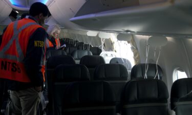 Members of the NTSB examine the hole in the fuselage plug area of Alaska Airlines Boeing 737 Max flight in which a door plug blew out in January 2024.