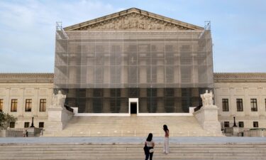 The Supreme Court on June 23 granted President Donald Trump’s emergency request to resume deporting migrants to countries other than their homeland. People take photos at the US Supreme Court at dusk on June 10 in Washington