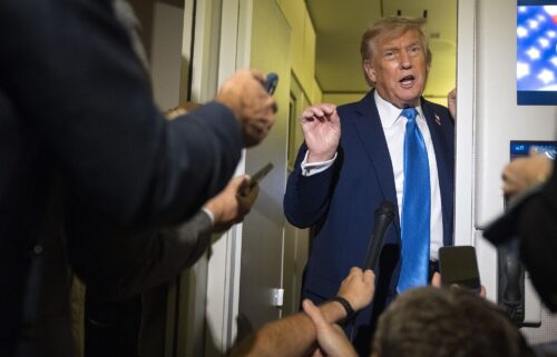 President Donald Trump speaks with reporters while flying aboard Air Force One en route from Calgary