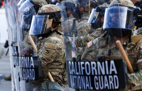 National Guard troops wear gas masks during protests against federal immigration sweeps