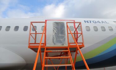 Plastic covers the exterior of the fuselage plug area of Alaska Airlines Flight 1282 Boeing 737-9 MAX in January 2024 in Portland