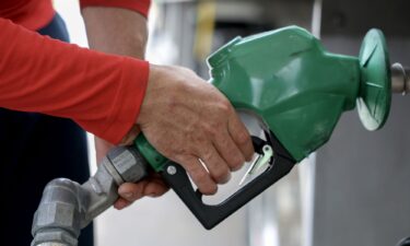 Arley Perez pumps diesel fuel into his truck at a Shell station on April 10