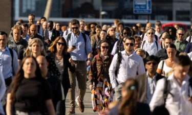 Commuters cross London Bridge in London on Wednesday