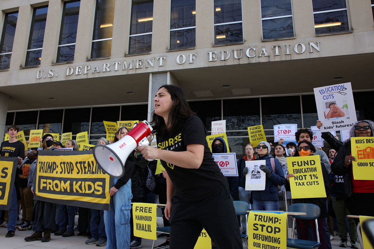Demonstrators gather outside the offices of the U.S. Department of Education in Washington